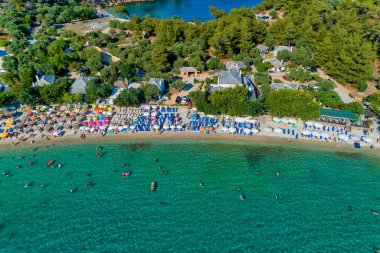 Aerial View of the Aliki Beach with colorful umbrellas, at Thass clipart