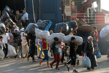 Refugees and migrants disembark to the port of Thessaloniki afte clipart