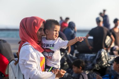 Refugees and migrants disembark to the port of Thessaloniki afte clipart