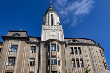 Debrecen, Hungary July 30, 2025  Peaceful square with neoclassical columns, timber framed building, benches, trees, and relaxed urban atmosphere.