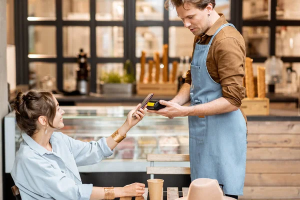 Garçom feliz com uma cliente feminina no café — Fotografia de Stock