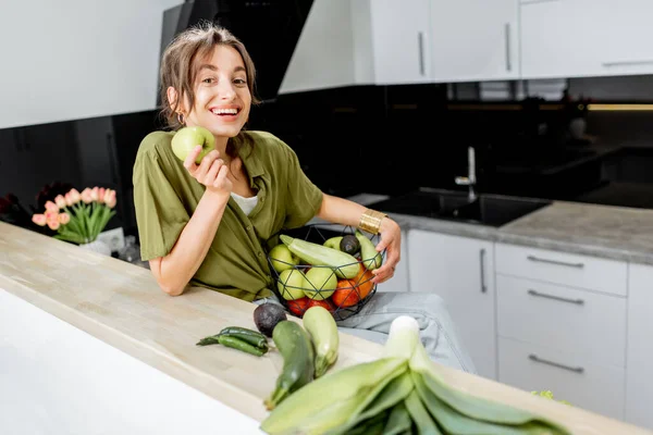 Retrato de una joven con comida sana en la cocina — Foto de Stock