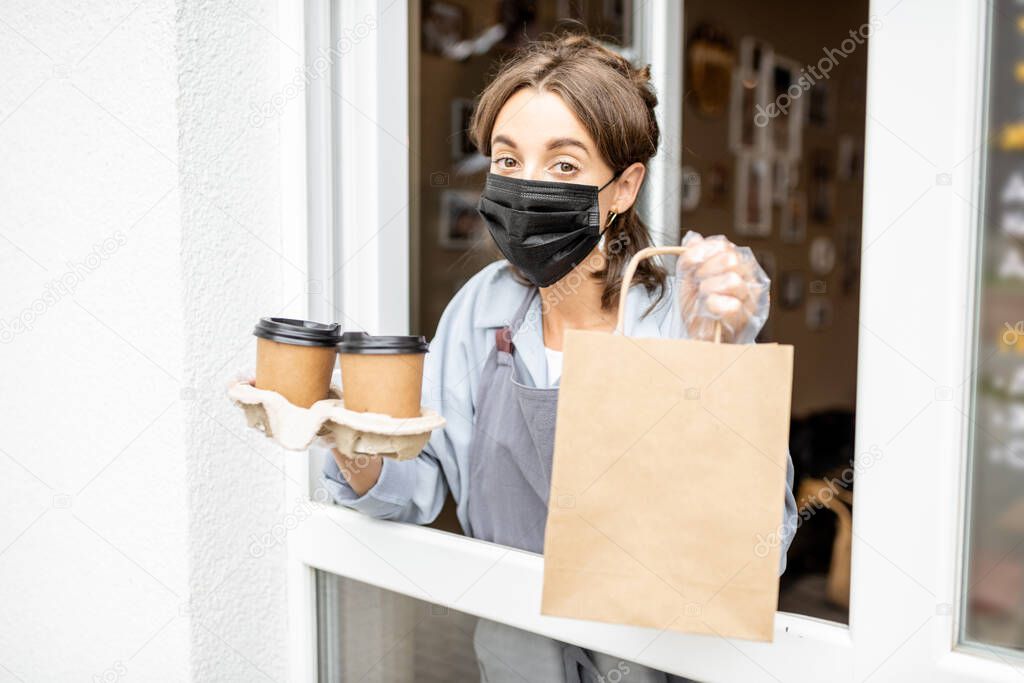 Woman with food to take away in the shop window