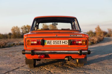 Pereshchepino, Ukrayna - 12 Ekim 2014: Zhiguli Vaz 2106 özgün orange, yayımlanan SSCB'ye 70 's. Yolun ortasında güneşli gün olmadan araba kenarında araba park