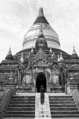Myanmar'da Bagan arkeolojik parkı içinde yer alan mimari Dhammayazika Pagoda önünde turist inf siyah beyaz resim