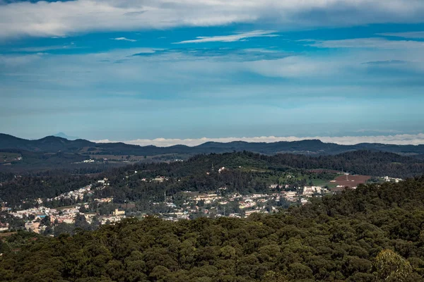 Dağ sırası ve tepeden gündüz görüntüsü ile şehir manzarası Doddabetta Peak Ooty India 'dan alınmıştır. Ooty City 'nin arka plandaki kuş bakışı görüntüsünü gösteriyor..