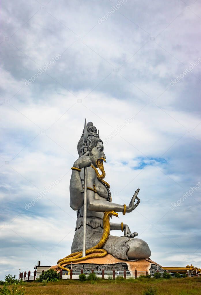 shiva statue isolated at murdeshwar temple close up shots from unique angle image is take at murdeshwar karnataka india at early morning. it is one of the tallest shiva statue in the world.