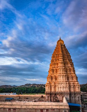 temple entrance with bright dramatic sky background at evening shot is taken at hampi karnataka india. it is showing the impressive architecture in hampi.