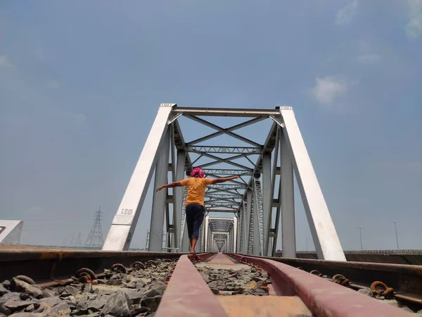 man at railway tracks iron bridge unique angle shot