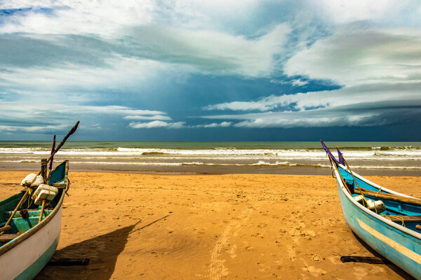 sea shore with boats and amazing sky at morning from flat angle image is taken at gokarna beach karnataka india.