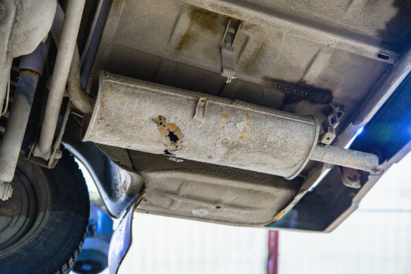 Old car muffler with shallow depth of field