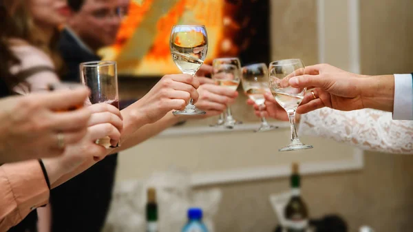 Hands with glasses at shallow depth of field — Stock Photo, Image