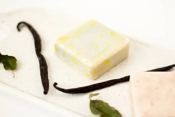 Olive Soap from soy wax with vanilla on white marble board . Natural cosmetics. Ecological soap.