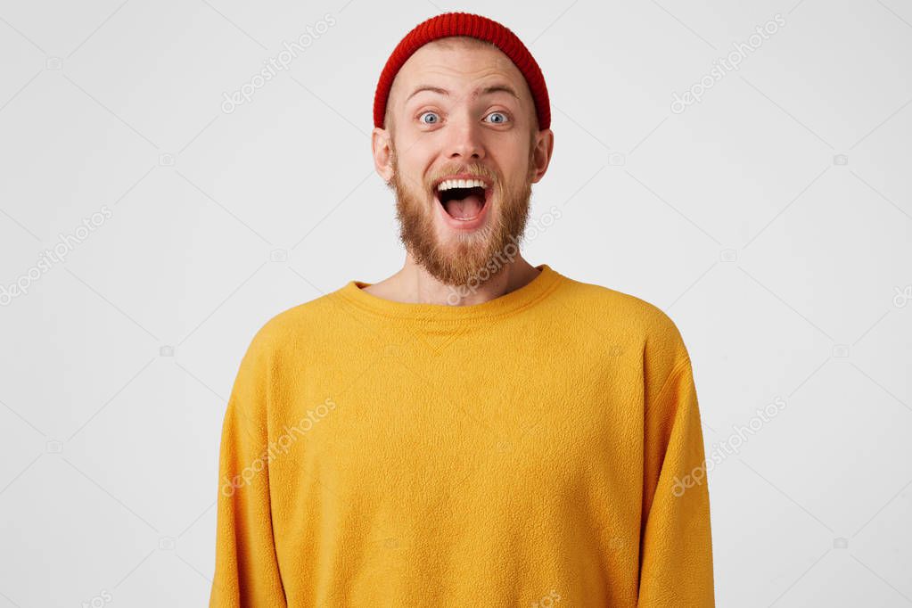 Happy guy is ready to jump from happiness. Bearded man with blue eyes overwhelmed with positive emotions, pleasantly surprised, reached results, won or gained success