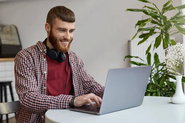 Smiling young attractive ginger bearded man, wearing in basic cl