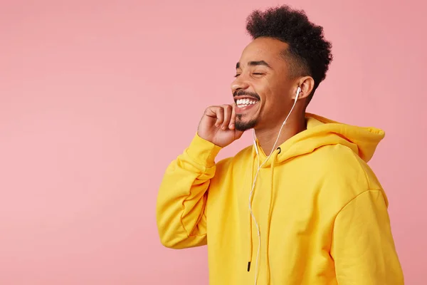 Close up of young happy african american man in yellow hoodie, e