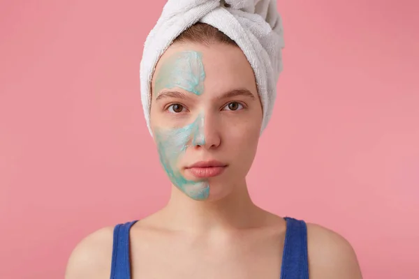 Close up of young nice lady with a towel on her head after showe