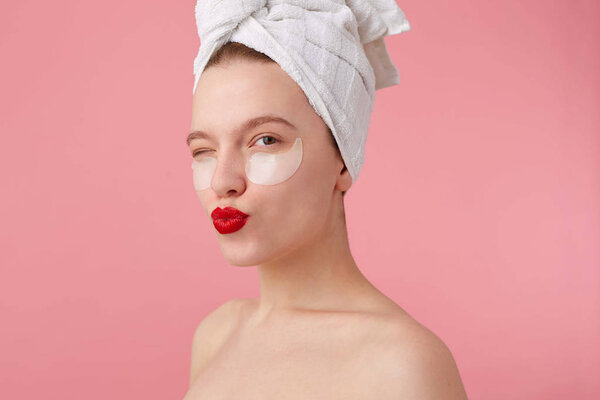 Close up of young woman with a towel on her head after shower, w