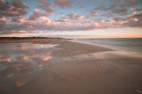 Beach and ocean in a national park in sweden, cloud reflections in the water 