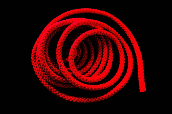 Red rope on a black background, folded rings.