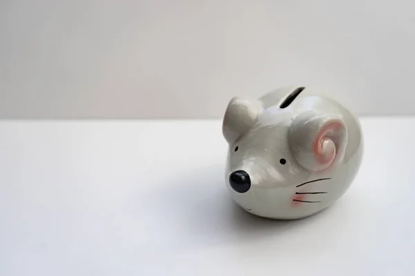 Ceramic piggy bank in the shape of a mouse.