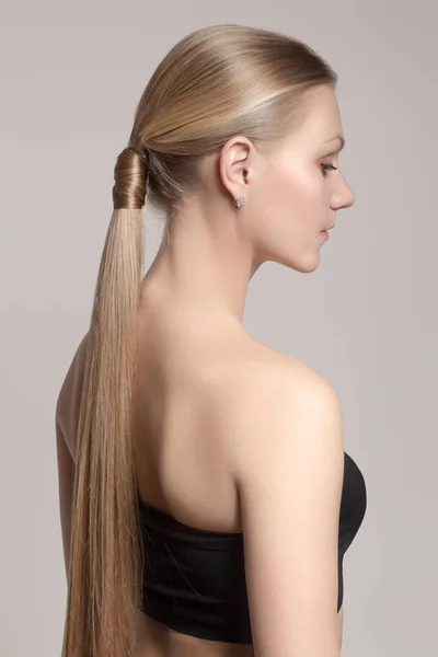 woman with a hair tail. Clean skin of the face. Blonde.