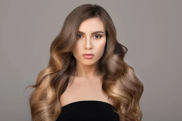 Uzun dalgalı saçlı, güzel bir esmer kadının portresi.