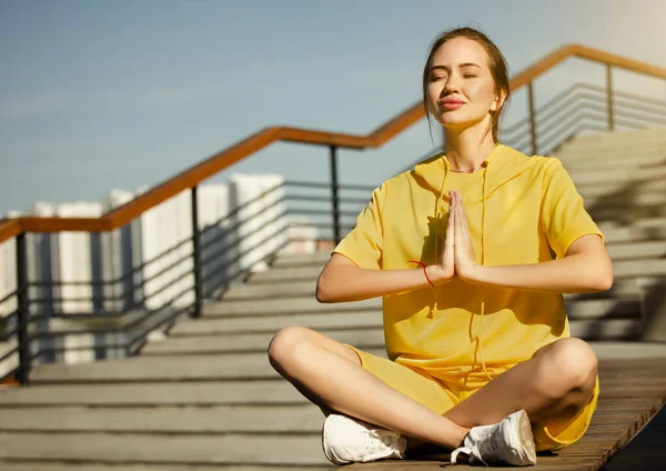 morning meditation in a city park. Woman in lotus position