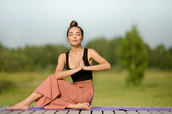 yoga in nature. Woman takes a pose. copycpase