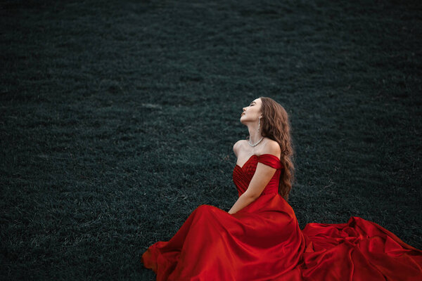 Young woman princess in a long red dress.