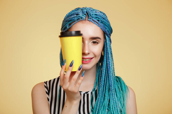 Portrait of a bright young woman on a yellow background