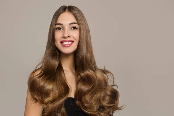 Esmer kadın saçı. Büyük bukleler. Gülümse.