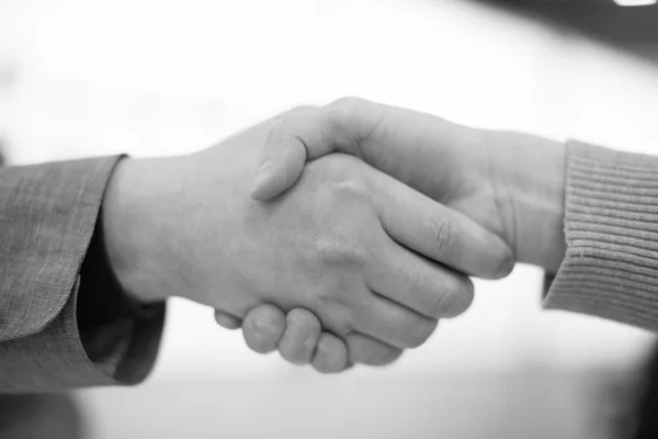 Handshake Black and White. Two People Hand Shaking in Partnership and Friendship. Business Deal and Working Together Cooperatively Concept. Business Suit and Casual Clothing. Corporate Agreement.