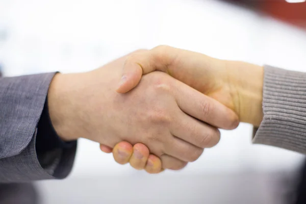 Partners shaking hands. Businessmen doing handshake in the city. Business etiquette, congratulations, or merger and acquisition concept. Successful business people or partnership deal meeting concept.