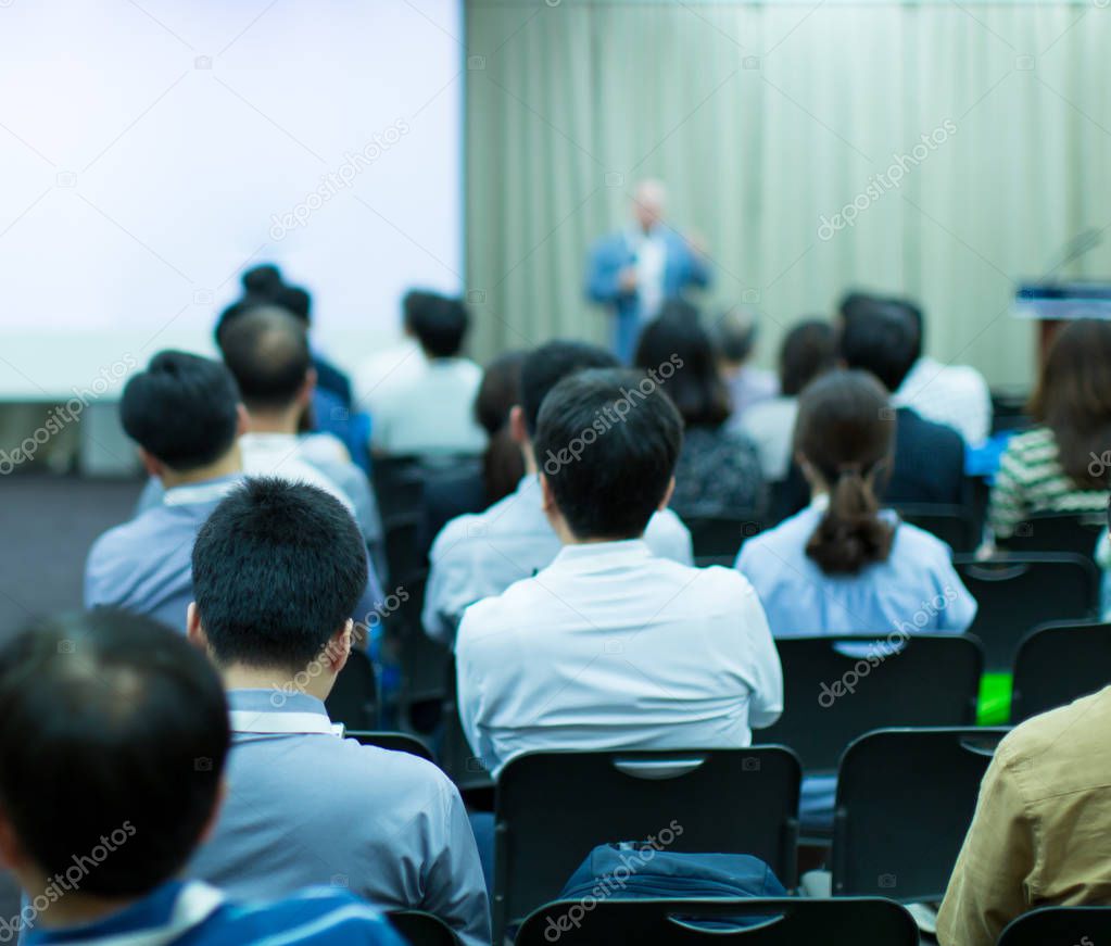 Conference photo audience and tech speaker giving speech. Seminar presenter at CEO forum. Corporate manager in executive training discussion on stage. Investor pitch presentation workshop picture.