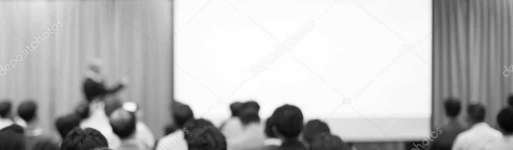 Blurred background with speech given by speaker on stage at corporate conference. Manager giving presentation  to audience at leadership workshop for entrepreneurs. Photo bokeh of people in meeting.