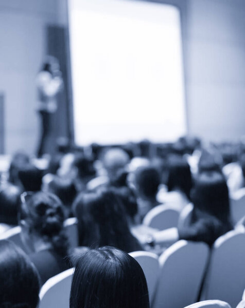 Tech speaker giving seminar to audience. Entrepreneurs in development workshop listen to presenter. Executive manager giving speech in conference hall. Technology executive in professional lecture.