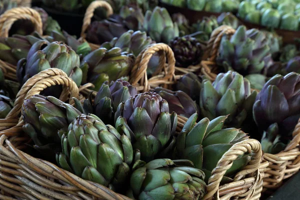 Biologic, natural cultivated artichoke, on a market counter.
