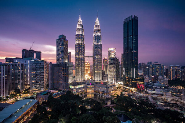 Kuala Lumpur, Malaysia - April 30, 2018: Kuala Lumpur City Centre aka KLCC complex including national landmark Petronas Twin Towers at twilight in Kuala Lumpur, Malaysia.
