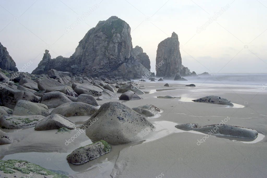 Portuguese remote rocky beach (Praia da Ursa, Bear beach) during low tide at dusk. Long exposure. ANALOG: 35 mm film.