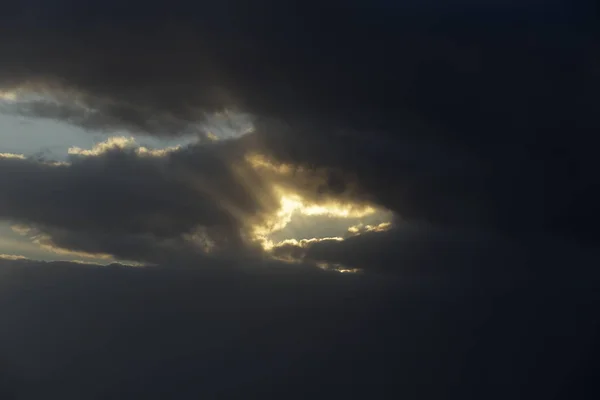 Dark cloudy sky with sunbeams in the evening — Stock Photo, Image