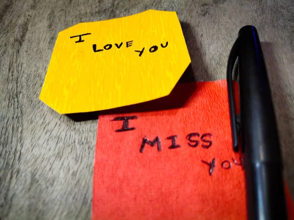 I love you written on yellow paper.