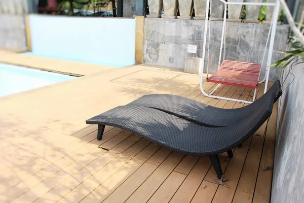 舒适的沙发床，带着伞，在游泳池 — 图库照片