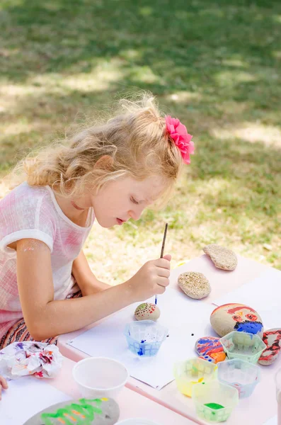 Cute Little Blond Child Concentrated Painting Stones — Stock Photo, Image