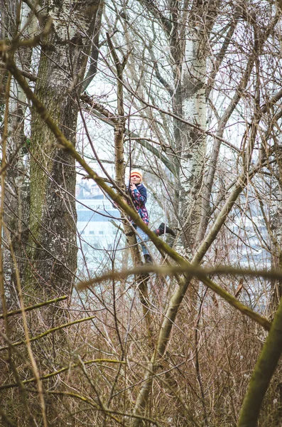 girl on tree in scary forest