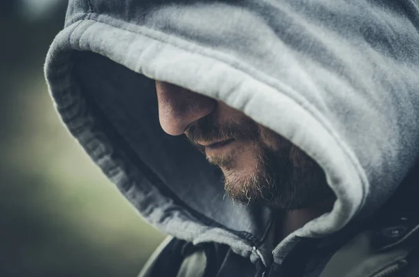 scary man hiding in hooded jacket