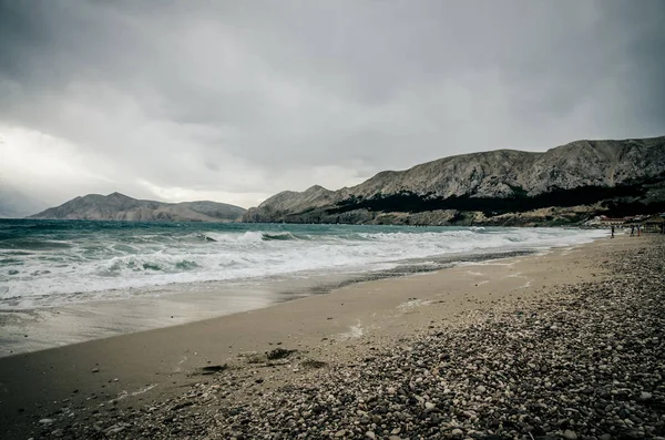 pebble beach and stormy sea with dramatic sky