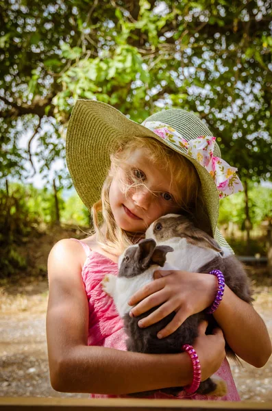 Adorável criança segurando um animal de estimação coelho — Fotografia de Stock