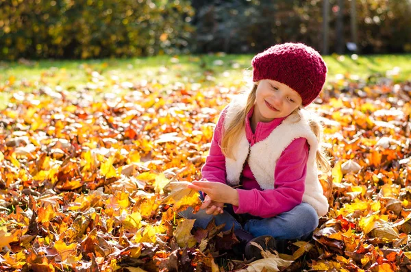 Adorable child in red cap in magic sunny afternoon — Stock Photo, Image
