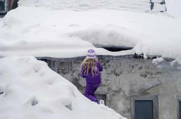 Little child in winter time looking for icicle — Stock Photo, Image